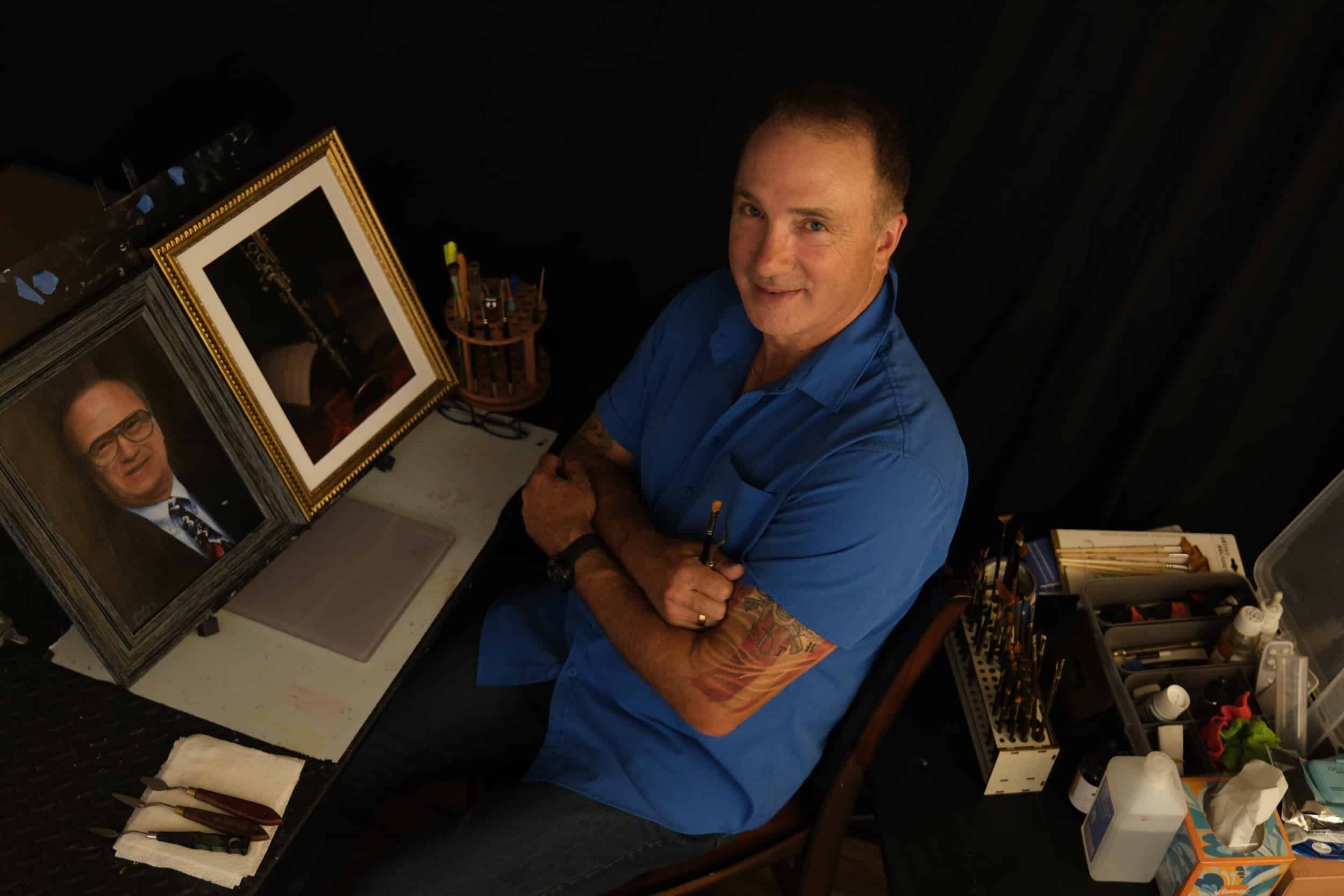 Bradley Hamilton | Narrative Oil Painter | Creator of Artist Saver(TM) Bradey Hamilton, creator Artist Saver(TM) in studio with paintings and tools.